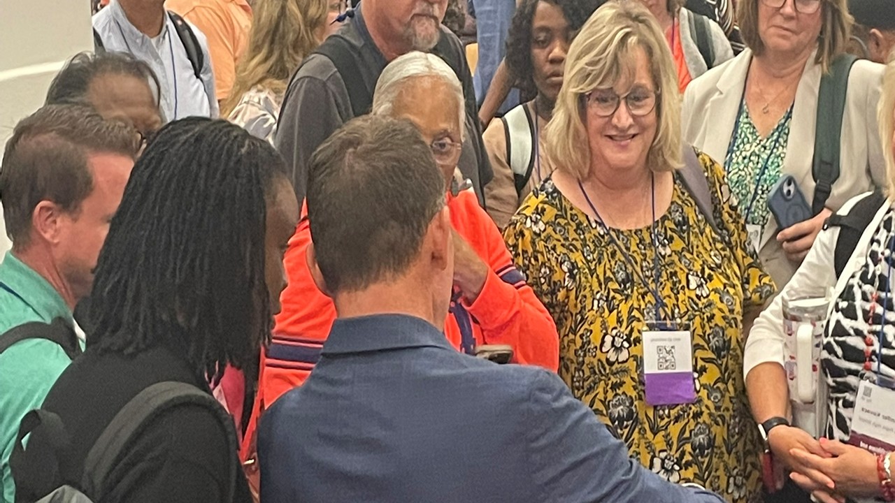 Audience members greeting Kevin during a post-keynote meet-and-greet